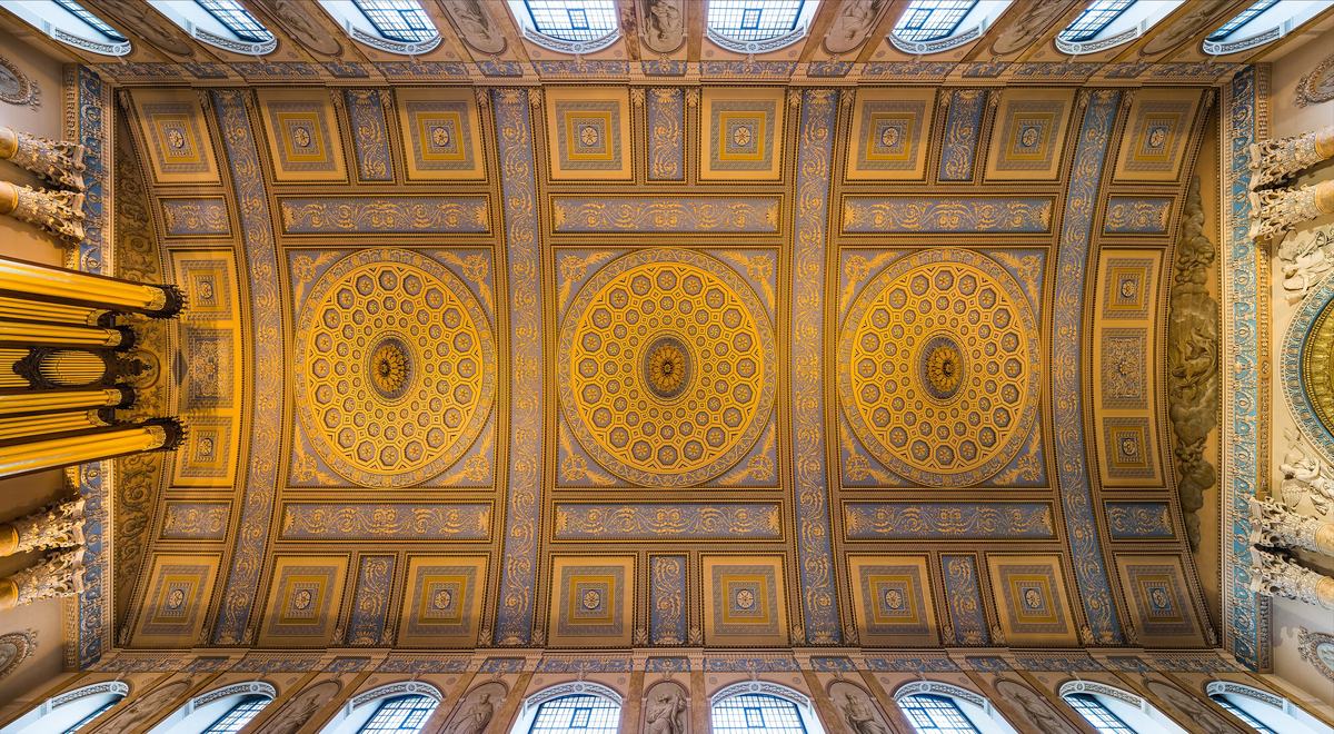 The ornate gold and white plaster ceiling of the chapel at the Old Royal Naval College, Greenwich.