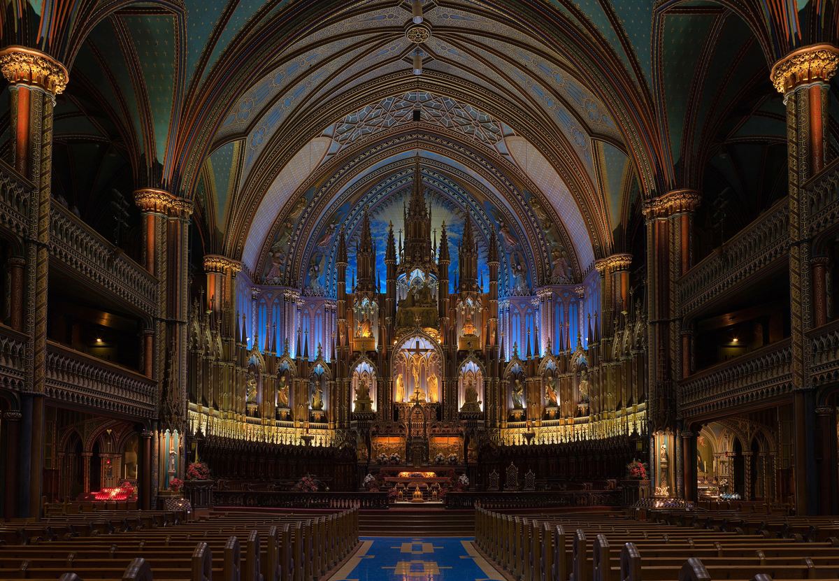 The deep blue and gold interior of Notre-Dame Basilica in Montreal, looking towards the altar.