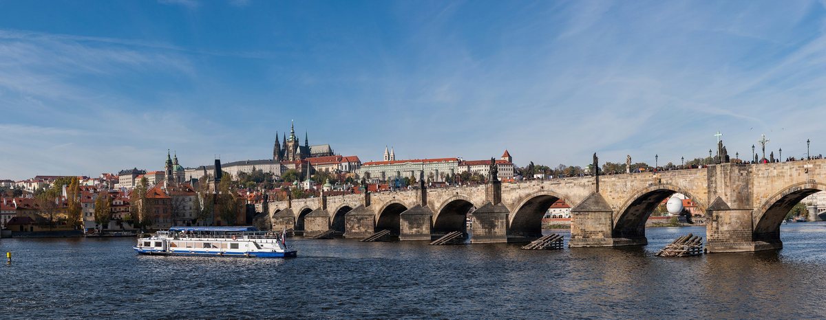 Charles Bridge crossing the Vltava with Prague Castle on the hill behind.