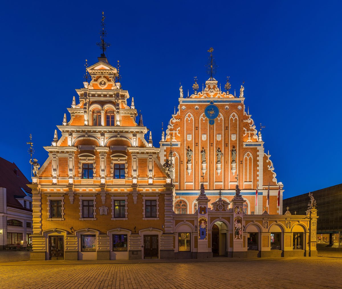 The ornate stepped gables of the House of Blackheads in Riga, floodlit at dusk.
